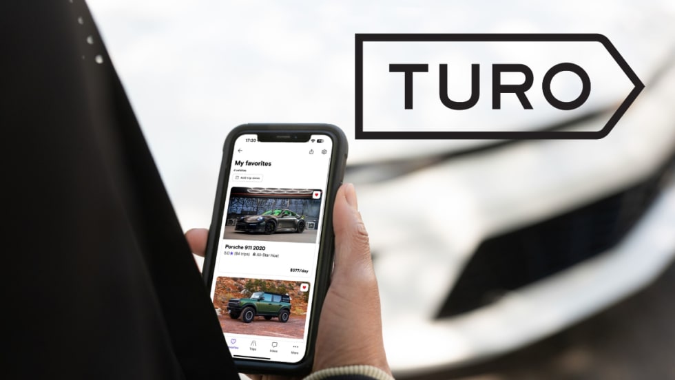 hand holding phone and Turo logo