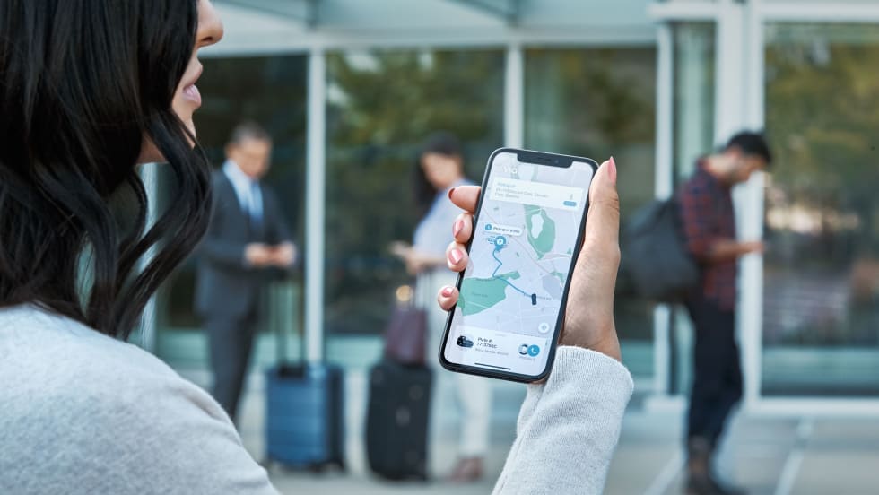 A rider looking at a Via map on a smartphone