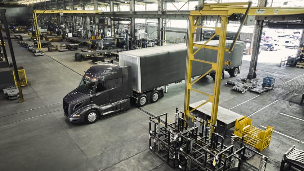 Photo of Volvo VNR pulling a trailer into building