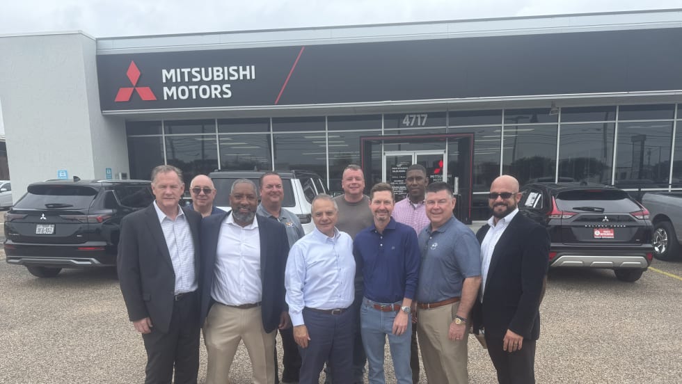 Photo of buyer and seller representatives in Waco Mitsubishi sale outside the dealership