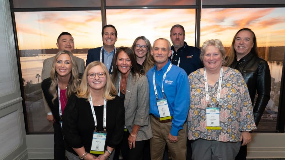 Attendees at a cocktail reception gather for a photo.