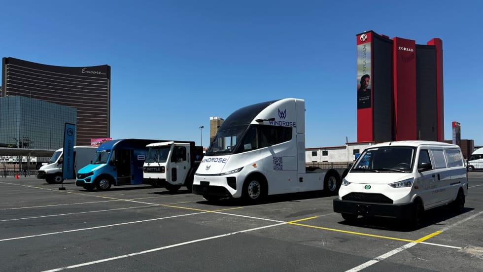 Alt-fuel and alt-power commercial vehicles in a parking lot at an exposition.