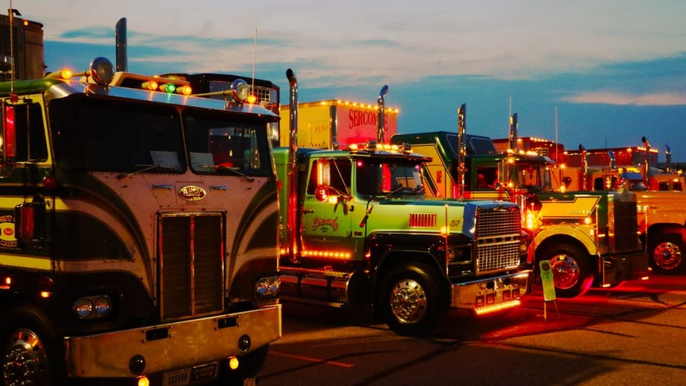 A line of antique trucks at sunset