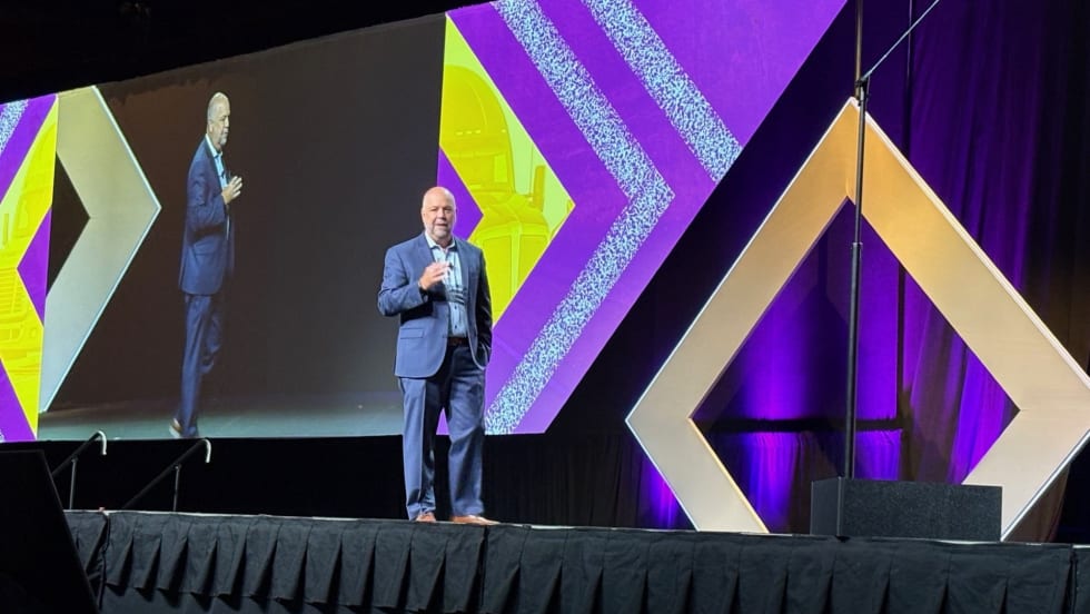 Man on convention stage