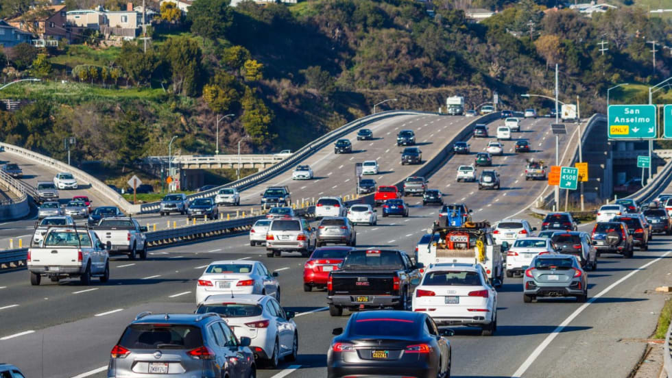 Car driving on a highway during the day.