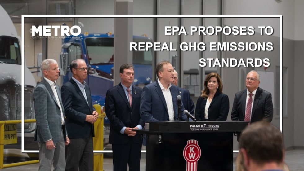 Officials in formal attire stand around a podium.