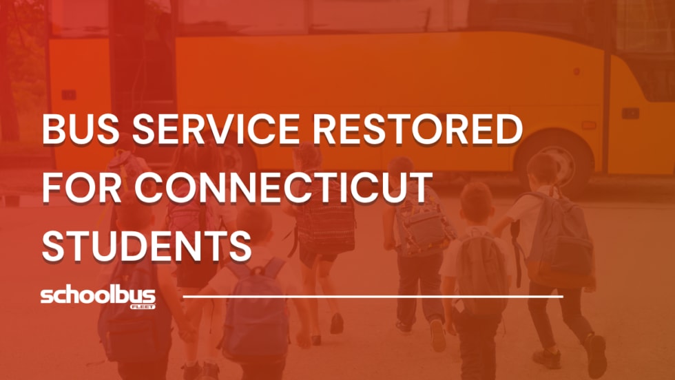 Group of elementary school students with backpacks walking toward a yellow school bus, representing restored bus service for Connecticut students.