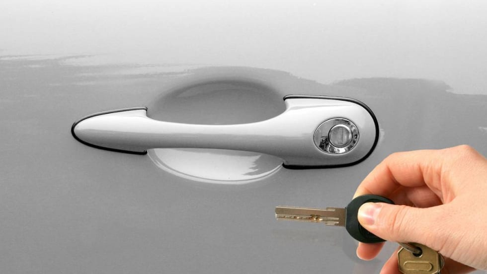 Car key next to keyhole.