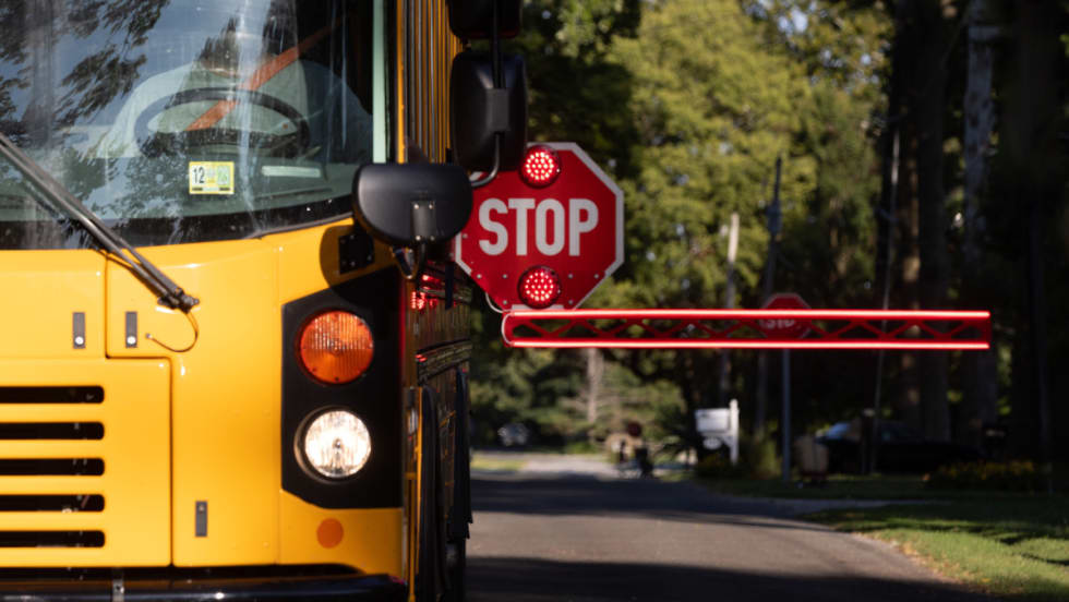 A BusGates extended stop-arm actively in use on a school bus.