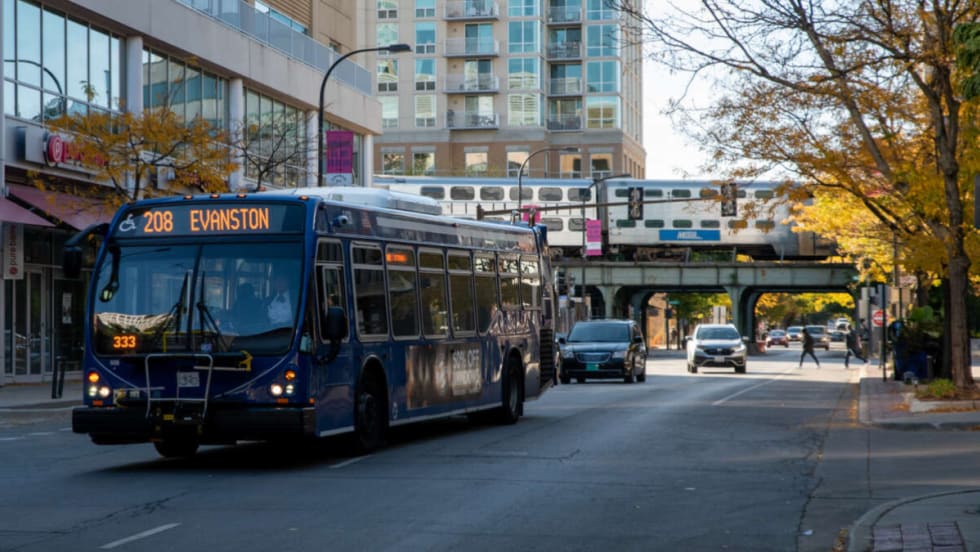A blue bus on a city street.