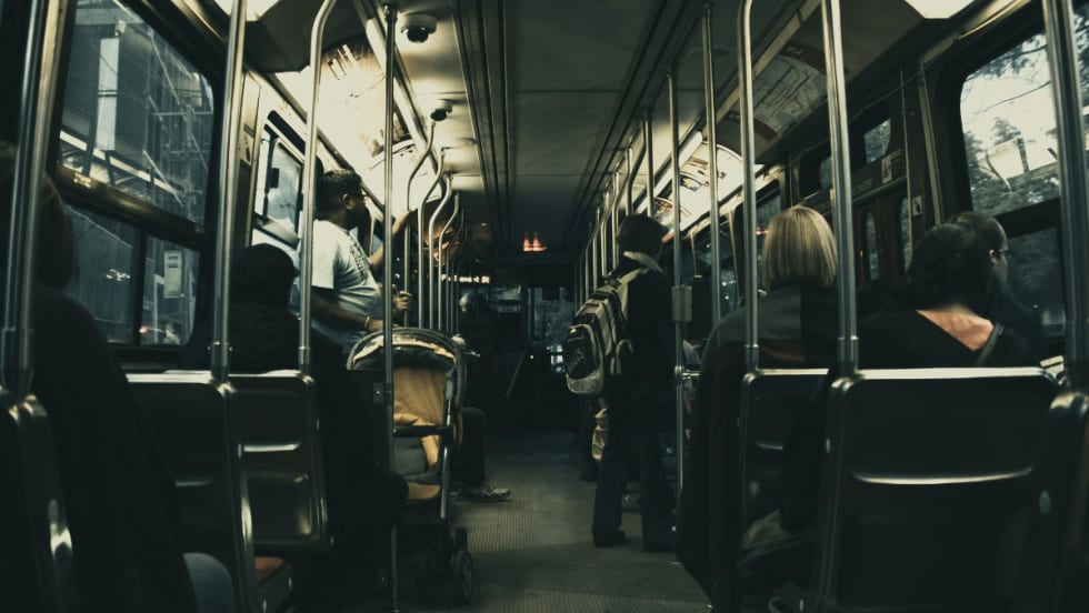 Rides on a public transit bus.