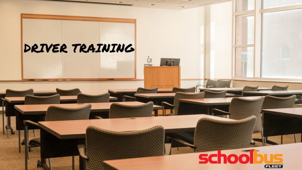 photo of an empty classroom with driver training on the whiteboard