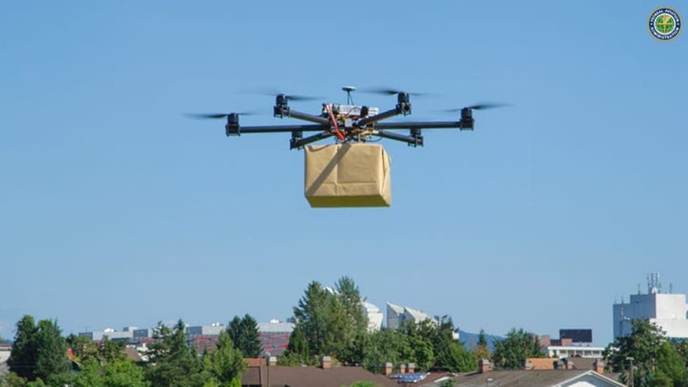 A drone carries a package for delivery.