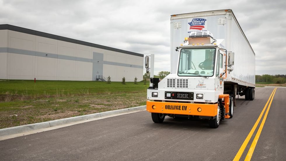 Orange EV terminal tractor. 