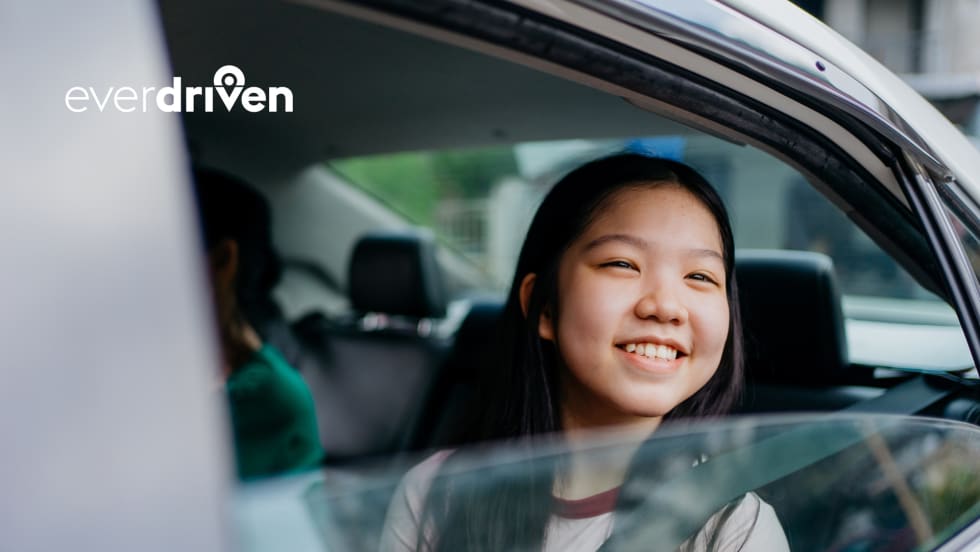 a girl sits in the backseat of a passenger car
