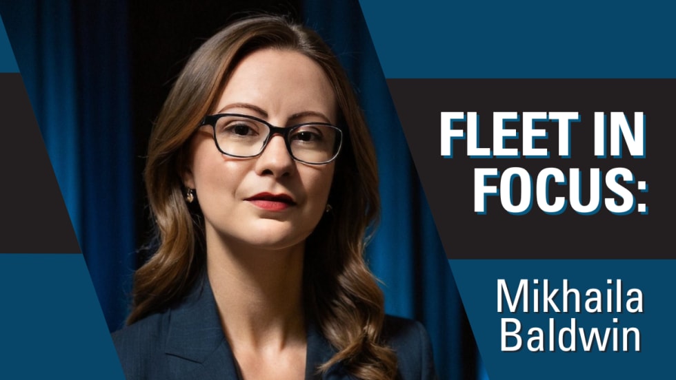 A professional portrait of Mikhaila Baldwin in a blue, white, and black graphic with text reading "Fleet in Focus: Mikhaila Baldwin".