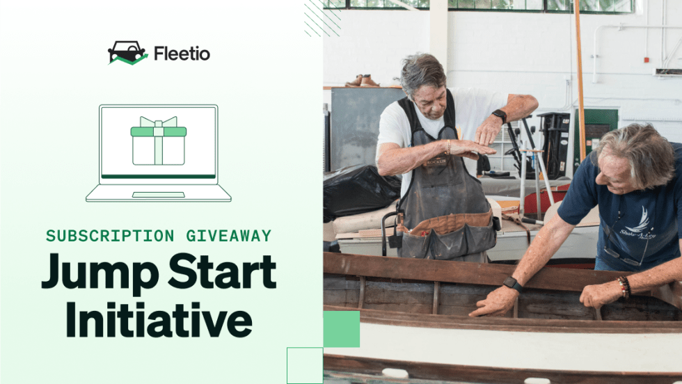 Two men working together on a wooden boat inside a workshop, alongside text for Fleetio’s Jump Start Initiative subscription giveaway