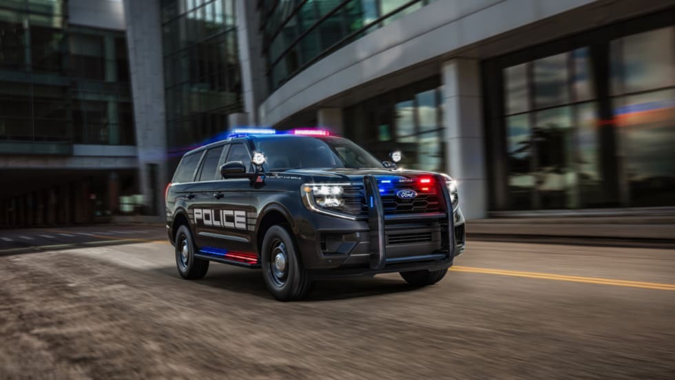 A black Ford Expedition SSV is shown driving down a city street.