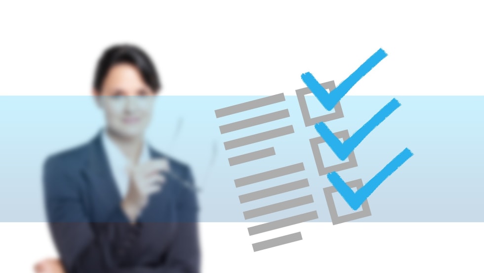 a blurred photo of a businesswoman in the background with a blue checklist overlay