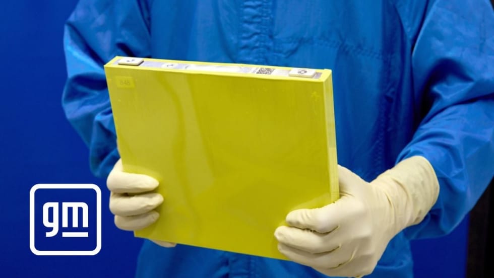 Man holding a new LMR battery by General Motors.