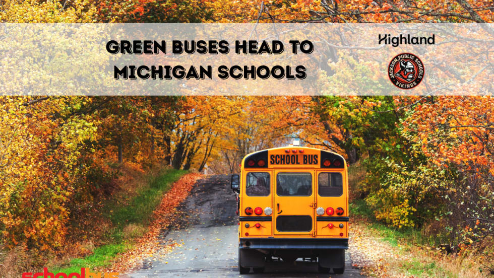 a school bus drives along a road in fall