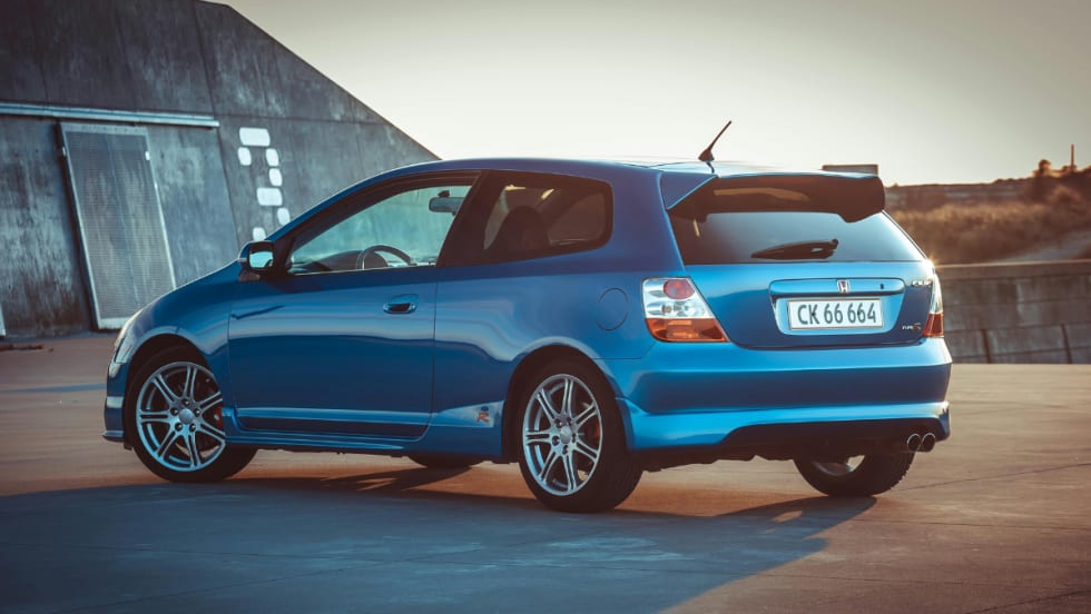 blue Honda hatchback outside