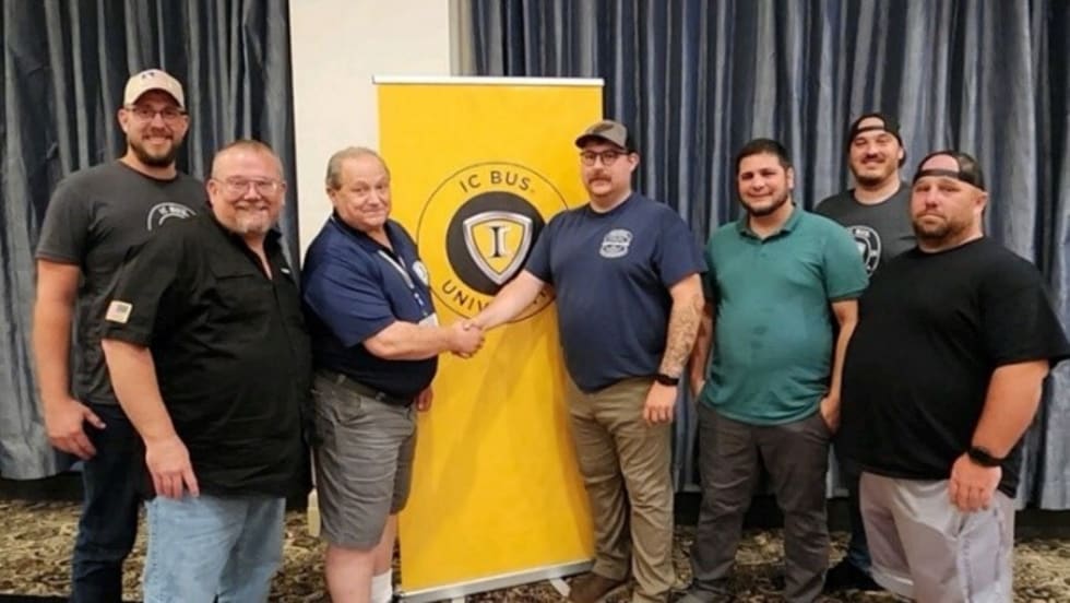 a group of men stand in a conference room