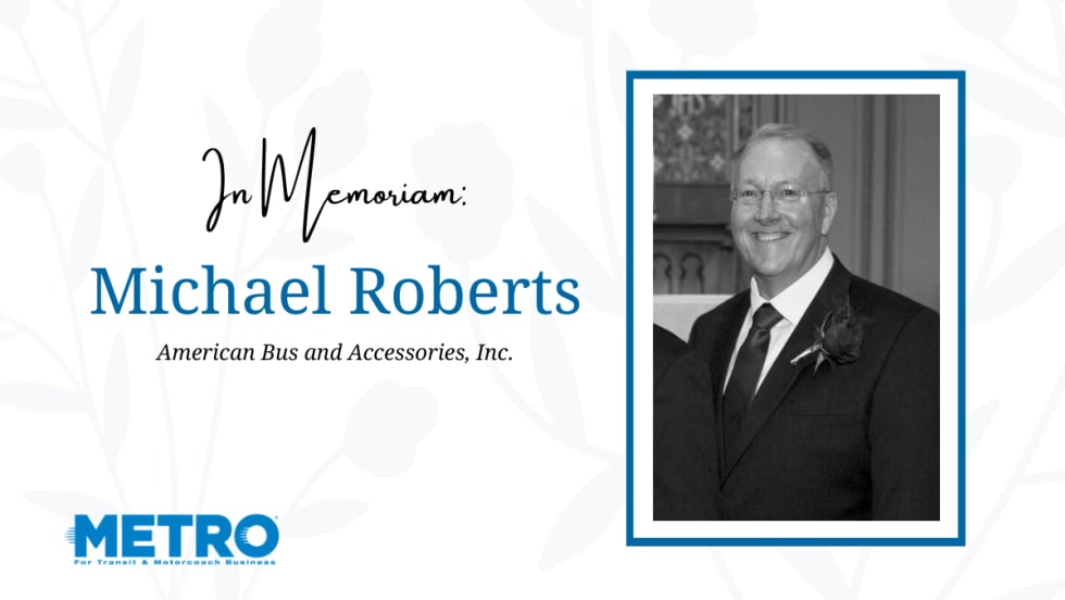 a black and white photo of michael roberts against a white flowery background with text that says "In memoriam Michael Roberts" and the metro logo