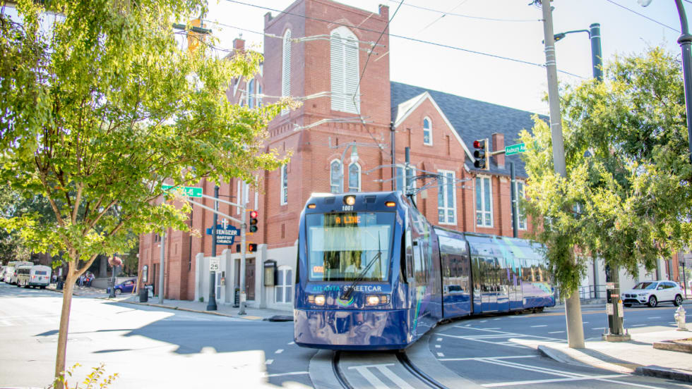 Blue A Line MARTA streetcar operating on the street.
