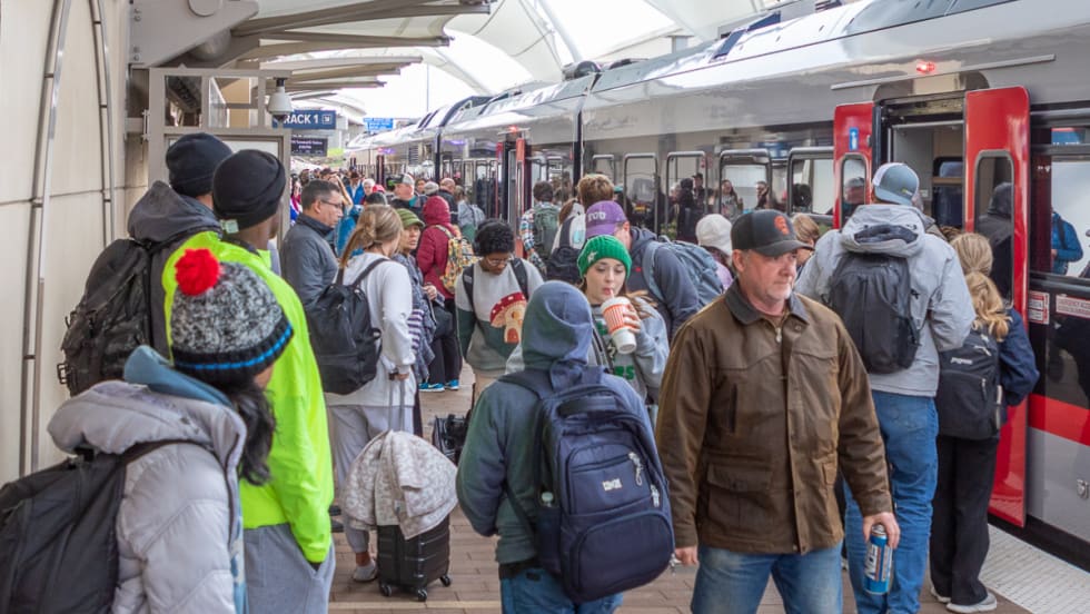 Airport goers wait to board Trinity Metro's TEXRail at DFW Airport.