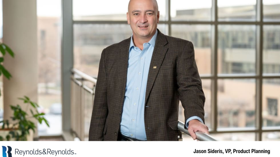 Jason Sideris, vice president of product planning at Reynolds and Reynolds, standing indoors at a company facility.