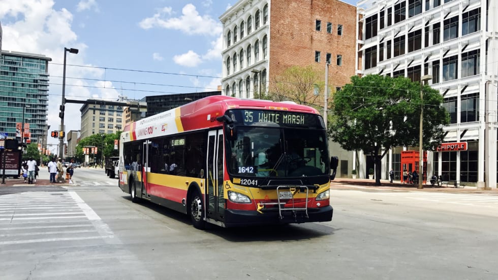 A red Maryland Transit Administration bus on the street.