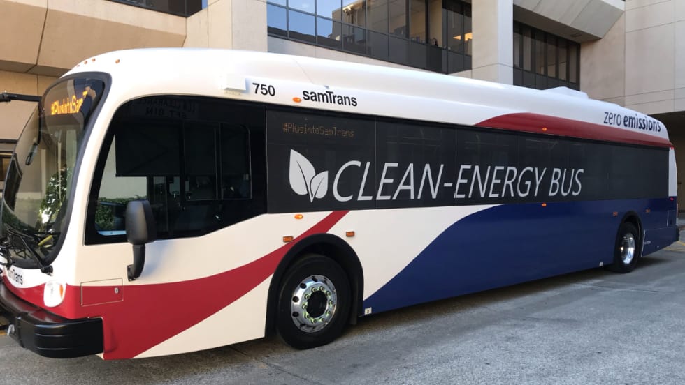 A red, white, and blue SamTrans clean-energy bus.