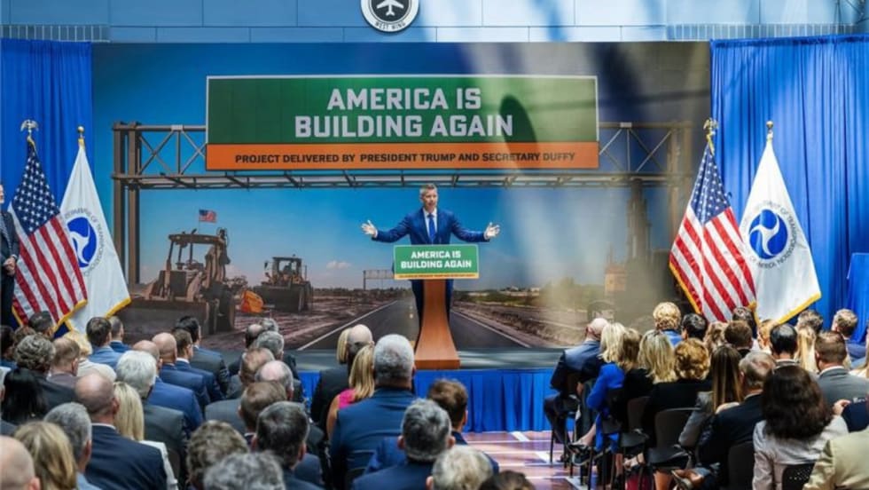 Transportation Secretary Sean Duffy speaks at a podium in front of a crowd.
