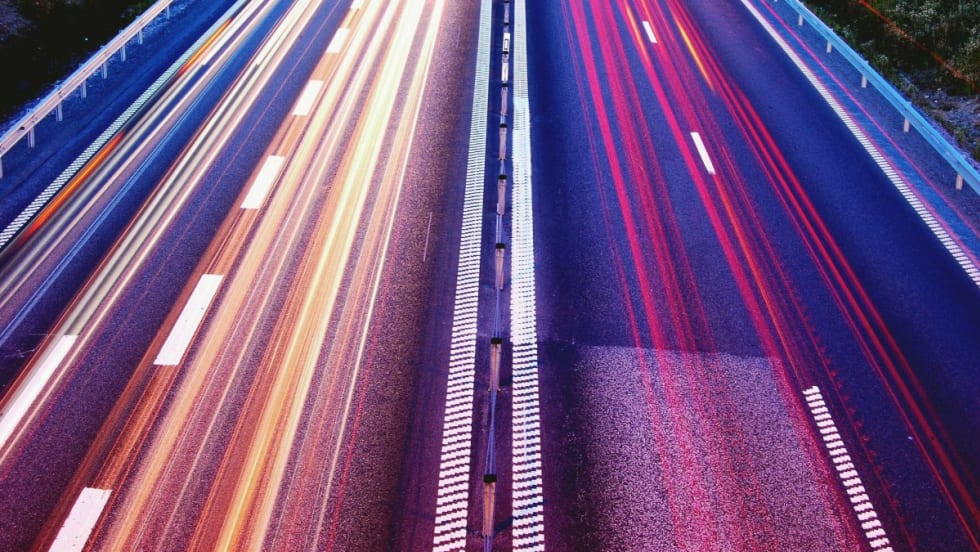 Rear view of a highway with multiple lanes of traffic.