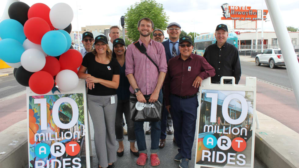 Rhett Sander-Spencer, ART's 10 millionth rider, posing for a picture with transit professionals.