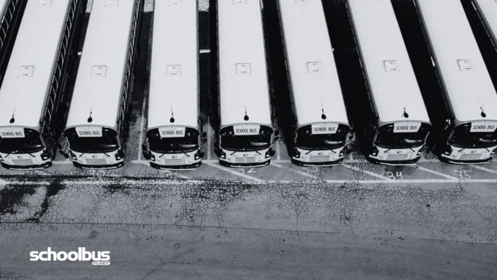 Black and white aerial view of a bus lot.