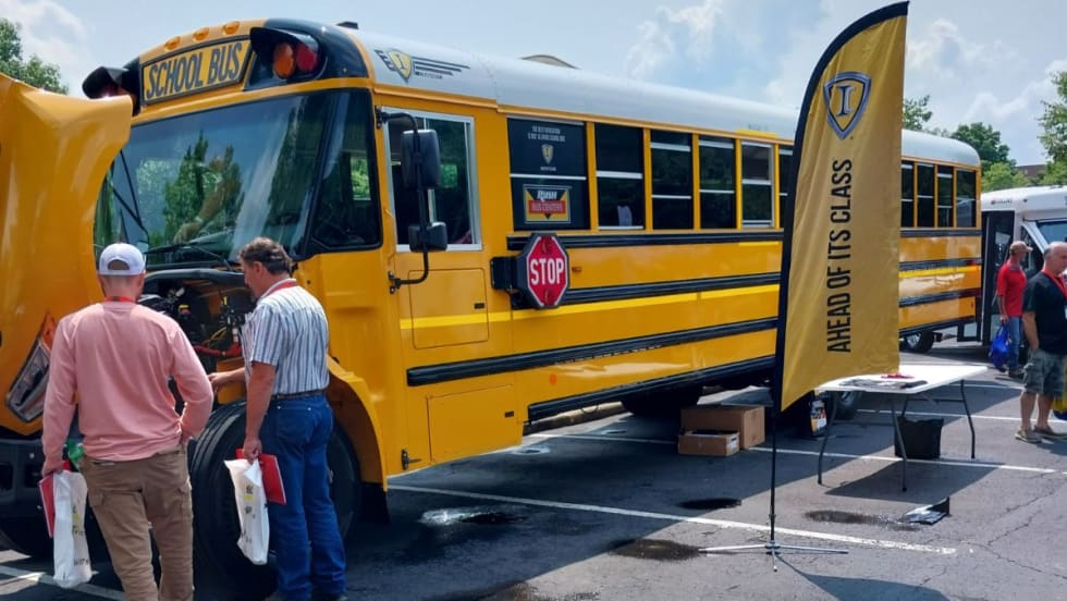 Attendees look at the engine of a bus at the 35th Annual Ohio School Bus Mechanics Association Workshop and Vendor Show.