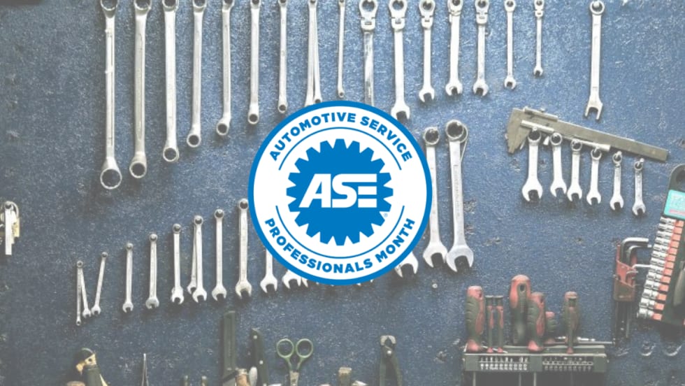 Blue and white Automotive Service Professionals logo presented over a blue background with various wrench tools. 
