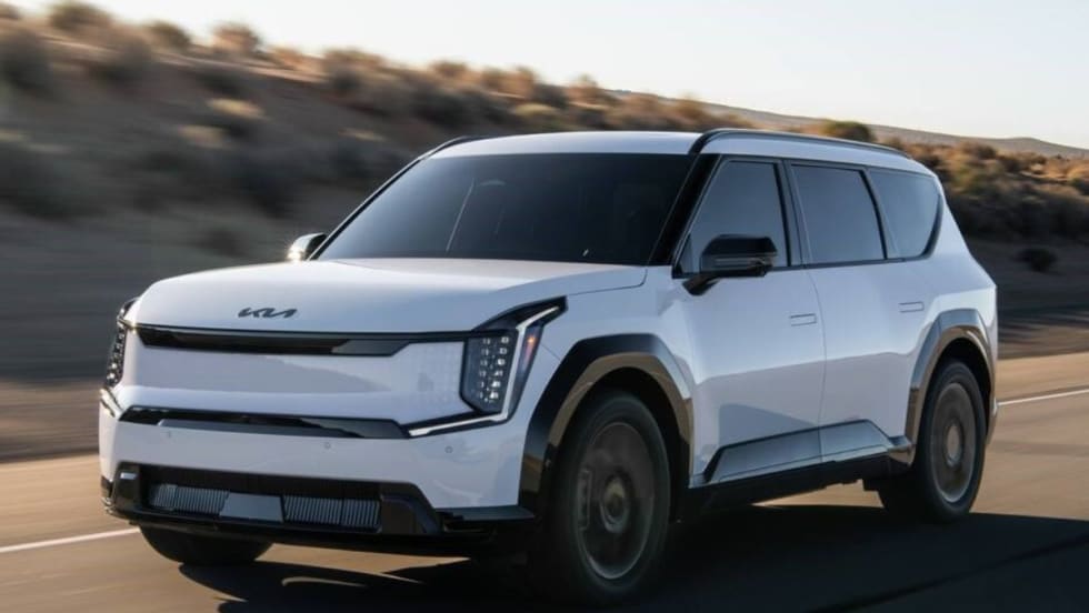 A 2026 Kia EV9 driving on the road.