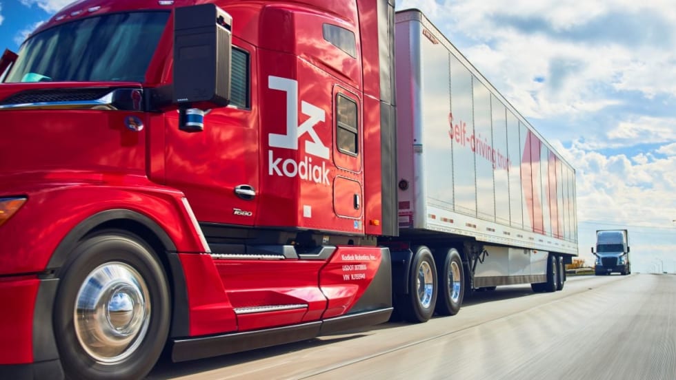 Red Kodiak autonomous truck with trailer on a highway