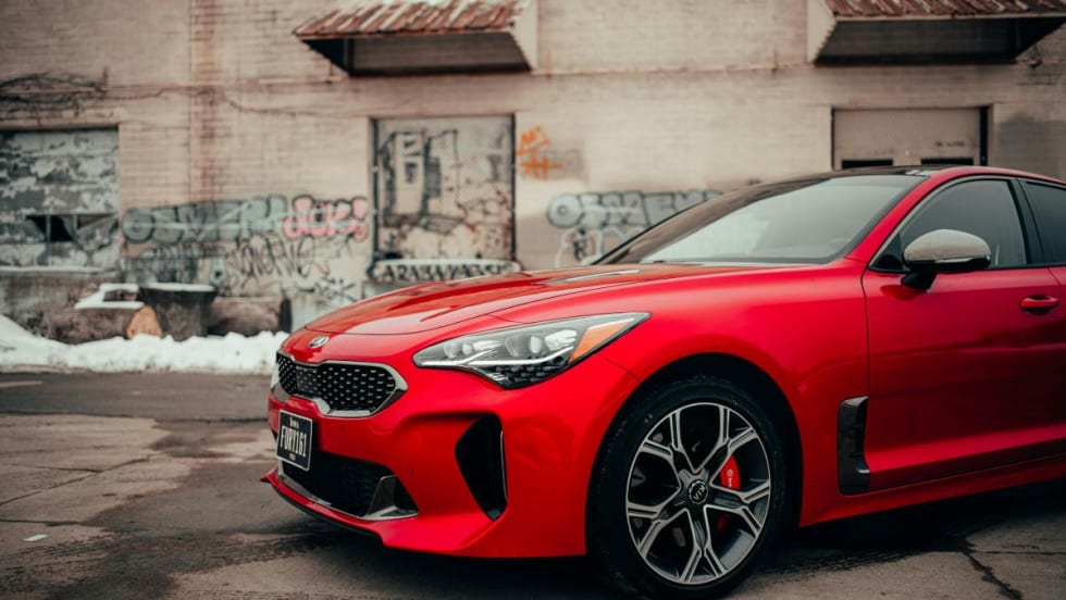 red Kia sedan parked outside