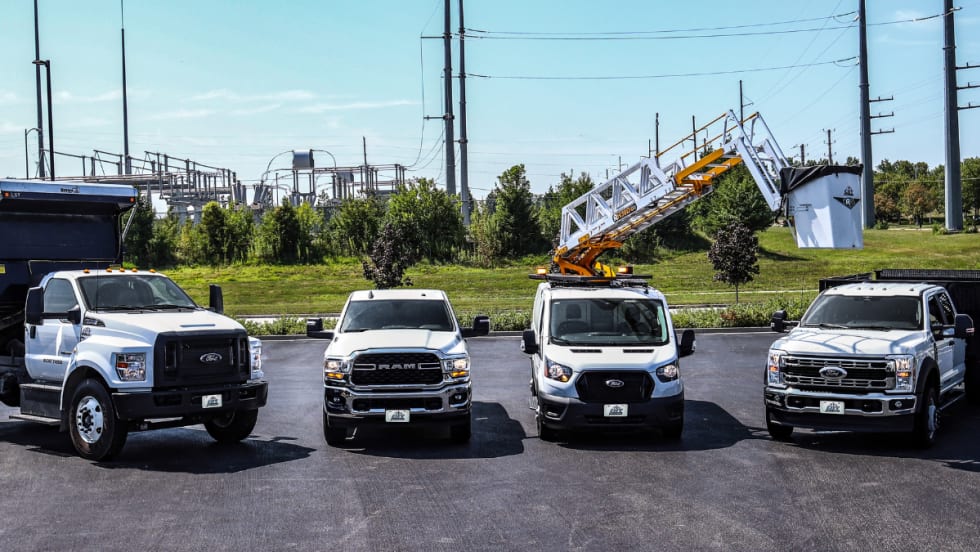 A lineup of work trucks and vans from City Rent a Truck.