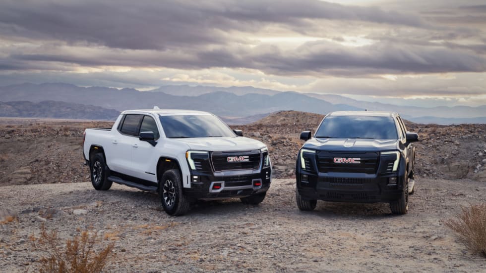 A white 2026 GMC Sierra EV AT4 trim and black Elevation trim.