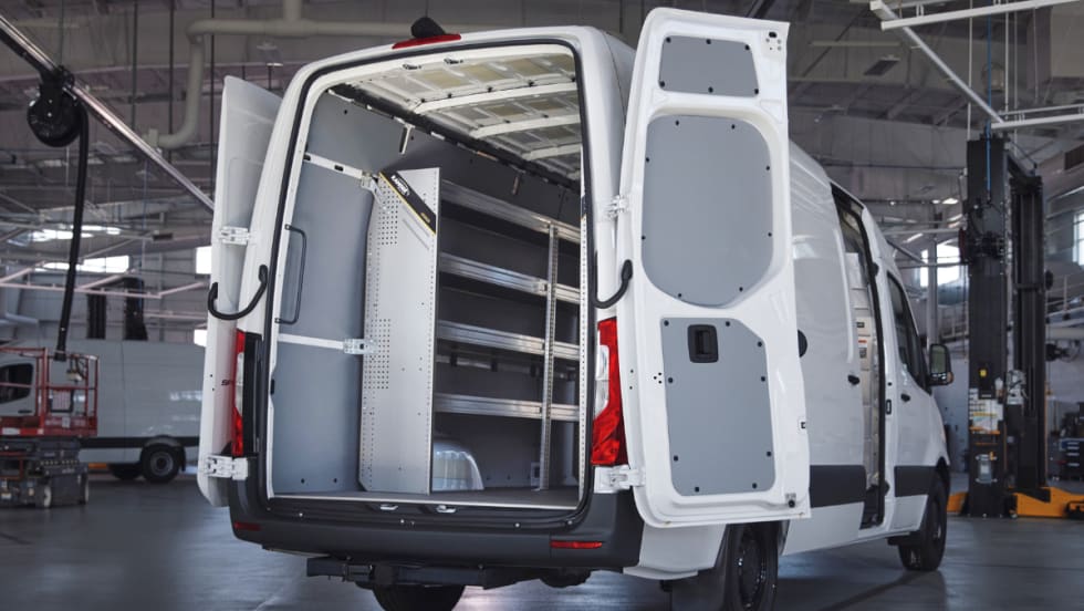 A Mercedes-Benz van with the back doors open.