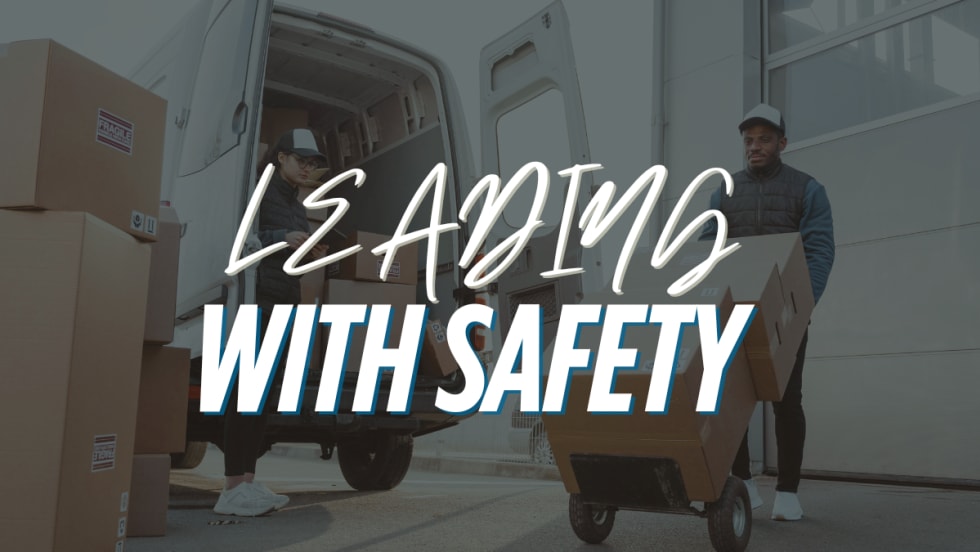 An image of people delivering boxes with text reading "Leading With Safety".