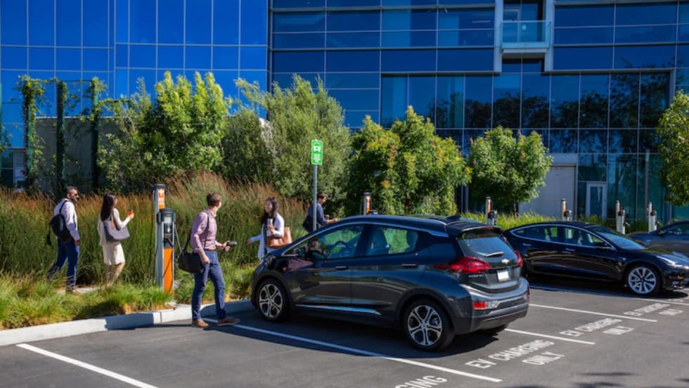 Parking lot in a business park with electronic vehicle charging stations.