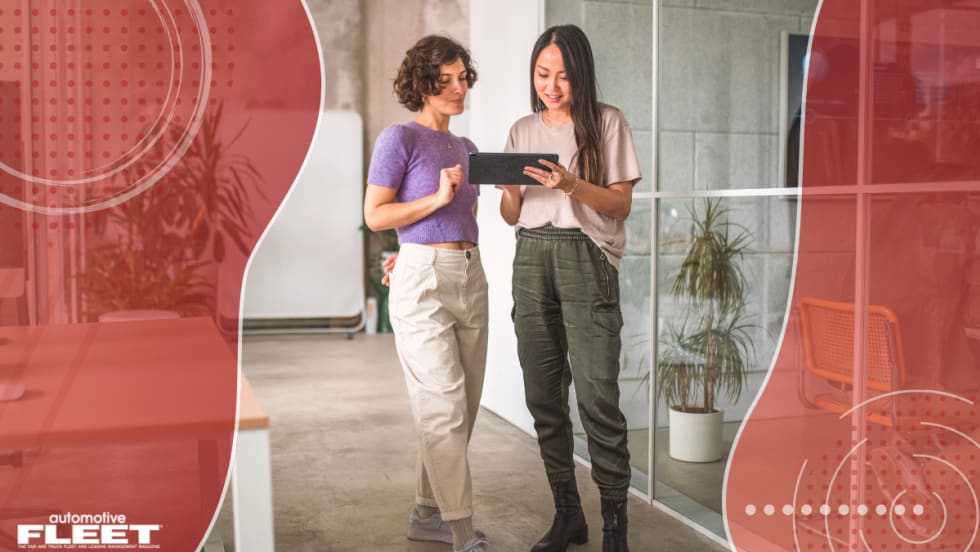 Red graphic of organic shapes with a picture of two women collaborating at work.