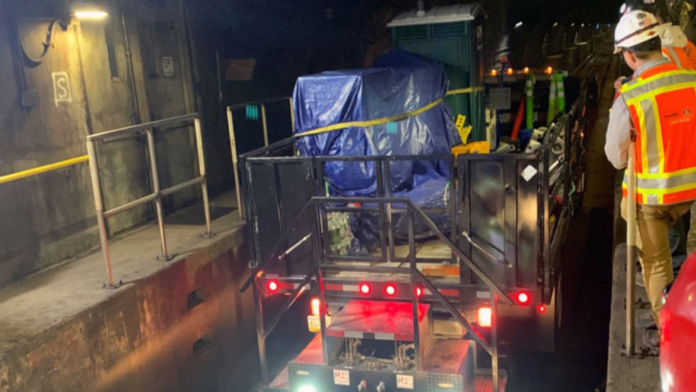 Rail workers enter Line 1 tunnel.