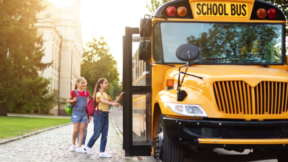 Children boarding a school bus.